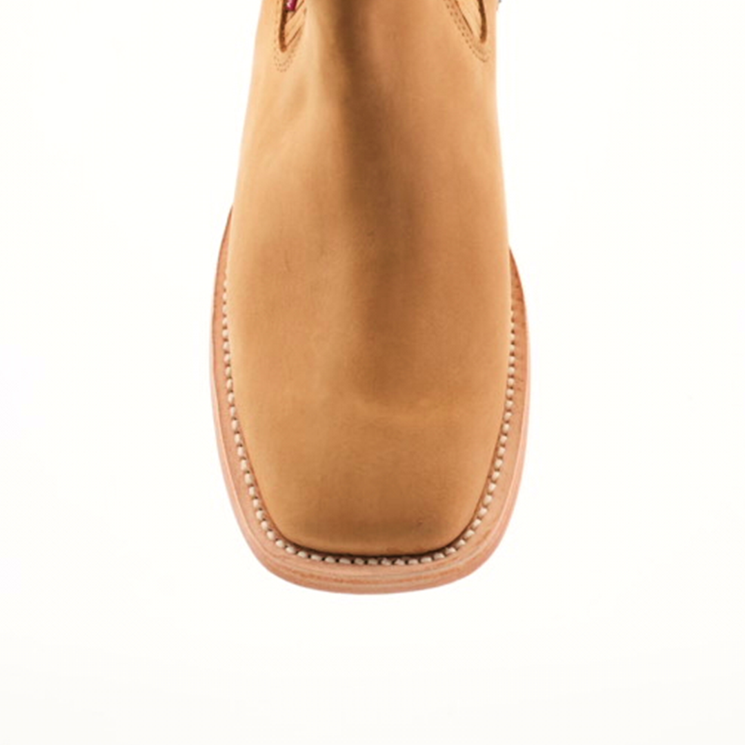 The Prime Suede Honey Square Toe features a stylish top view of an ankle boot with visible stitching on the sole and a trendy square toe, set against a plain white background, ideal for those who love modern cowboy fashion.