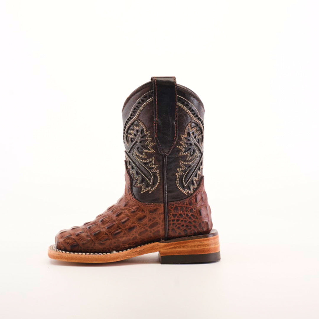 The Caiman Hornback Print Chocolate Square Toe is a single cowboy boot featuring exceptional leather craftsmanship with a brown, crocodile-patterned foot and a black shaft adorned with intricate embroidery, all set against a plain white background.