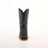 A front-facing view of a single Caiman Belly Print Black Square Toe cowboy boot exhibits an intricate black leather design, a pointed toe, and a light brown sole set against a plain white backdrop—ideal for cowboy enthusiasts.