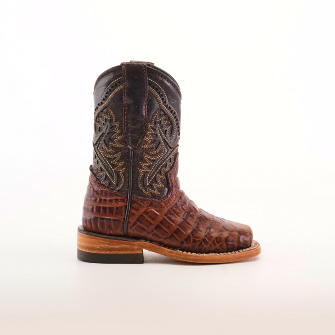 The Caiman Belly Print Chocolate Square Toe boot displays intricate embroidery on its upper and a Caiman Belly Print on the lower. Handcrafted from premium leather, it features a wooden sole and square toe, all set against a plain white background.