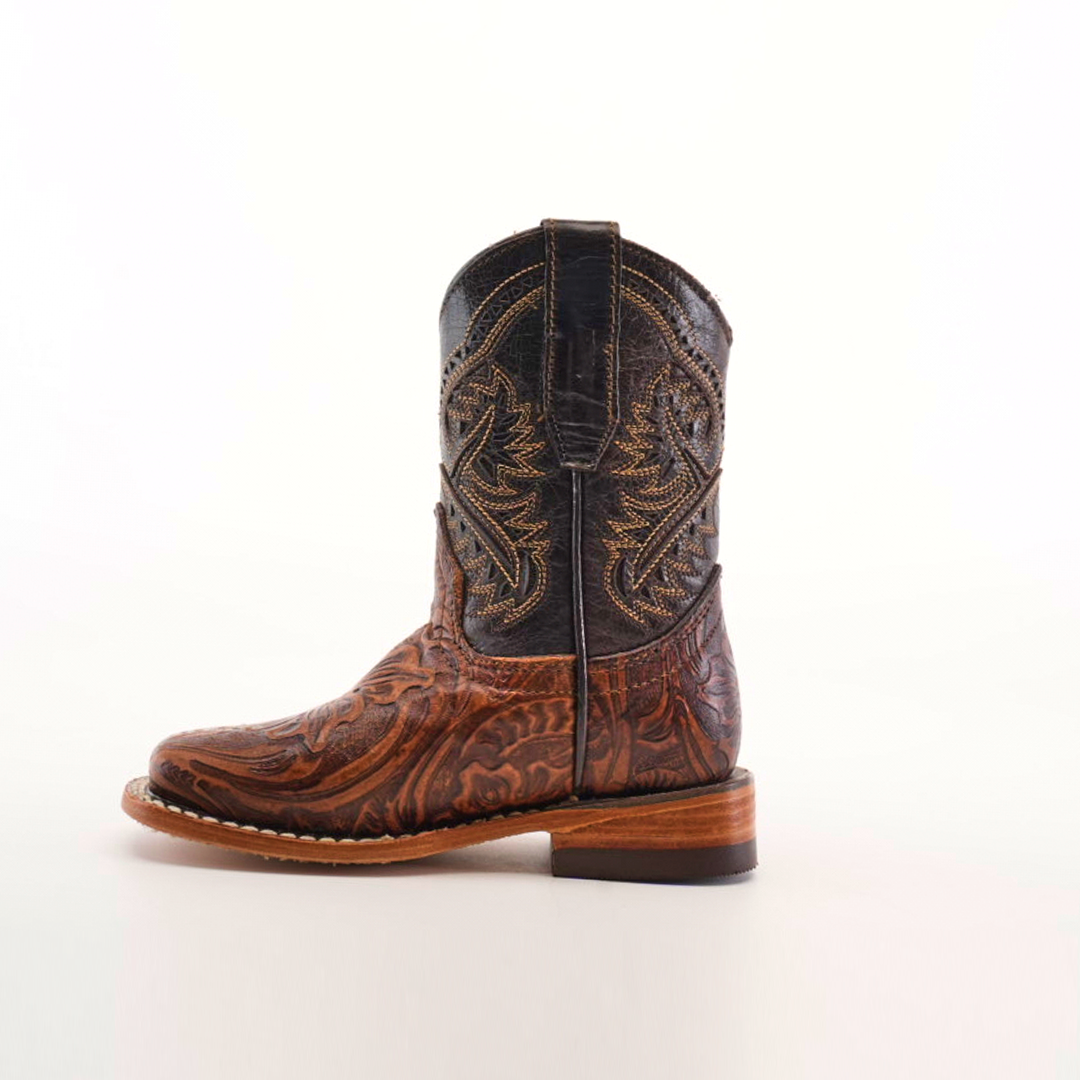 The Handtooled Leave Brown Square Toe is a single side-view cowboy boot crafted from premium cowhide leather, featuring intricate stitching and design on a white background.