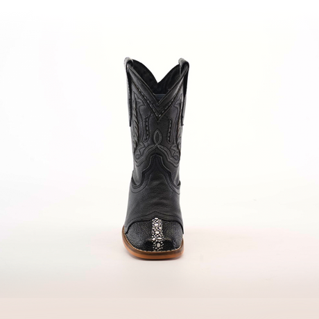 The Stingray Half Cowhide Print Black Rodeo Toe is a black cowboy boot made from cowhide leather with detailed stitching and a textured toe pattern. It features a brown sole and is showcased against a plain white background, exuding classic western charm.