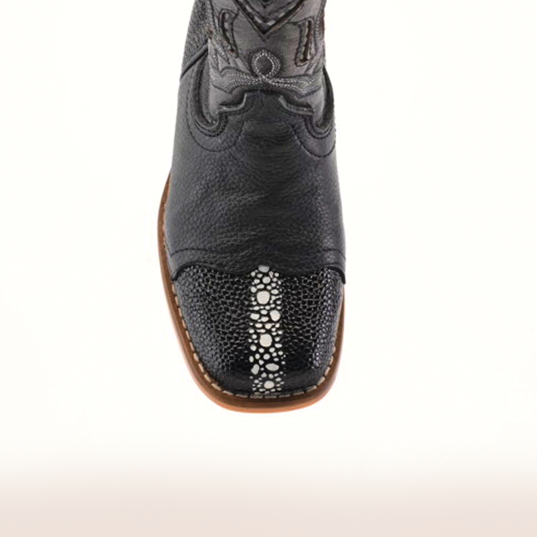 The Stingray Half Cowhide Print Black Rodeo Toe boot, made from cowhide leather, showcases western charm with its intricate toe pattern and white stitching. It features a brown sole and detailed shaft design, displayed from above against a plain backdrop.