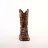 The Loggerhead Turtle Print brown Rodeo Toe cowboy boot boasts a detailed design with intricate shaft patterns and a rugged foot texture, all crafted from premium cowhide leather and showcased against a plain white background.