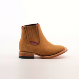 The Prime Suede Honey Square Toe is a tan leather cowboy boot featuring a square toe, decorative stitching, a branded label, and an easy slip-on side elastic panel. Its genuine leather provides a classic, rugged design set against a plain white background.