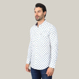 A bearded man stands slightly right against a light gray background, embodying casual elegance in dark jeans and the Mens Western Modern Fit White Long Sleeve Shirt with Snaps—WPL10387, showcasing its blue geometric pattern.