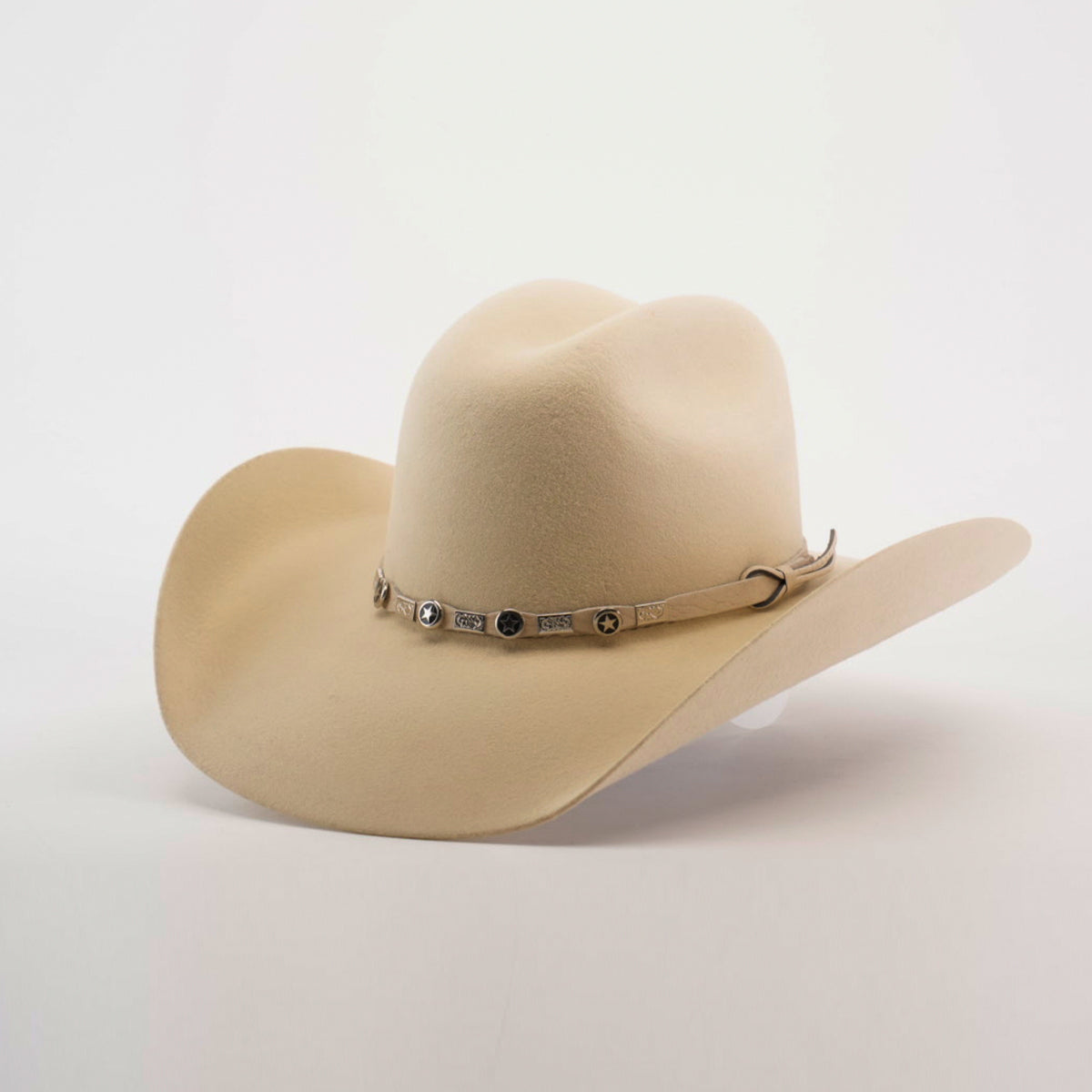 The 6X Chihuahua Bone is a cream-colored felt hat with a wide brim and a decorative band with metal accents around the crown, displayed against a white background.