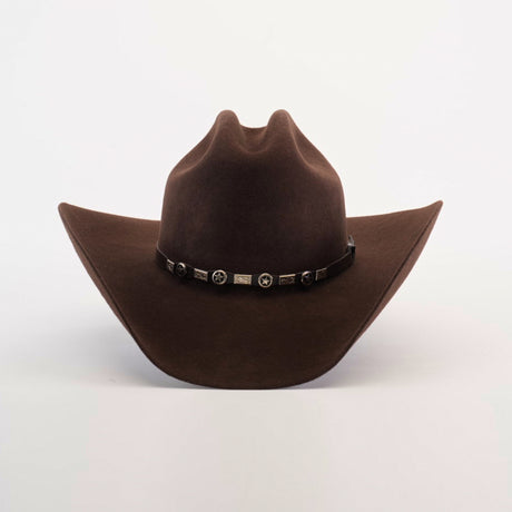 The 6X Country Brown is a Western classic felt cowboy hat made from premium sheep wool. It has a wide brim, pointed crown, and is adorned with a decorative black band featuring silver star accents on a plain white background.