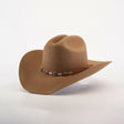 The 6X Country Fawn is a stylish brown felt cowboy hat with a wide brim and a leather band adorned with silver ornaments, displayed on a crisp white background.