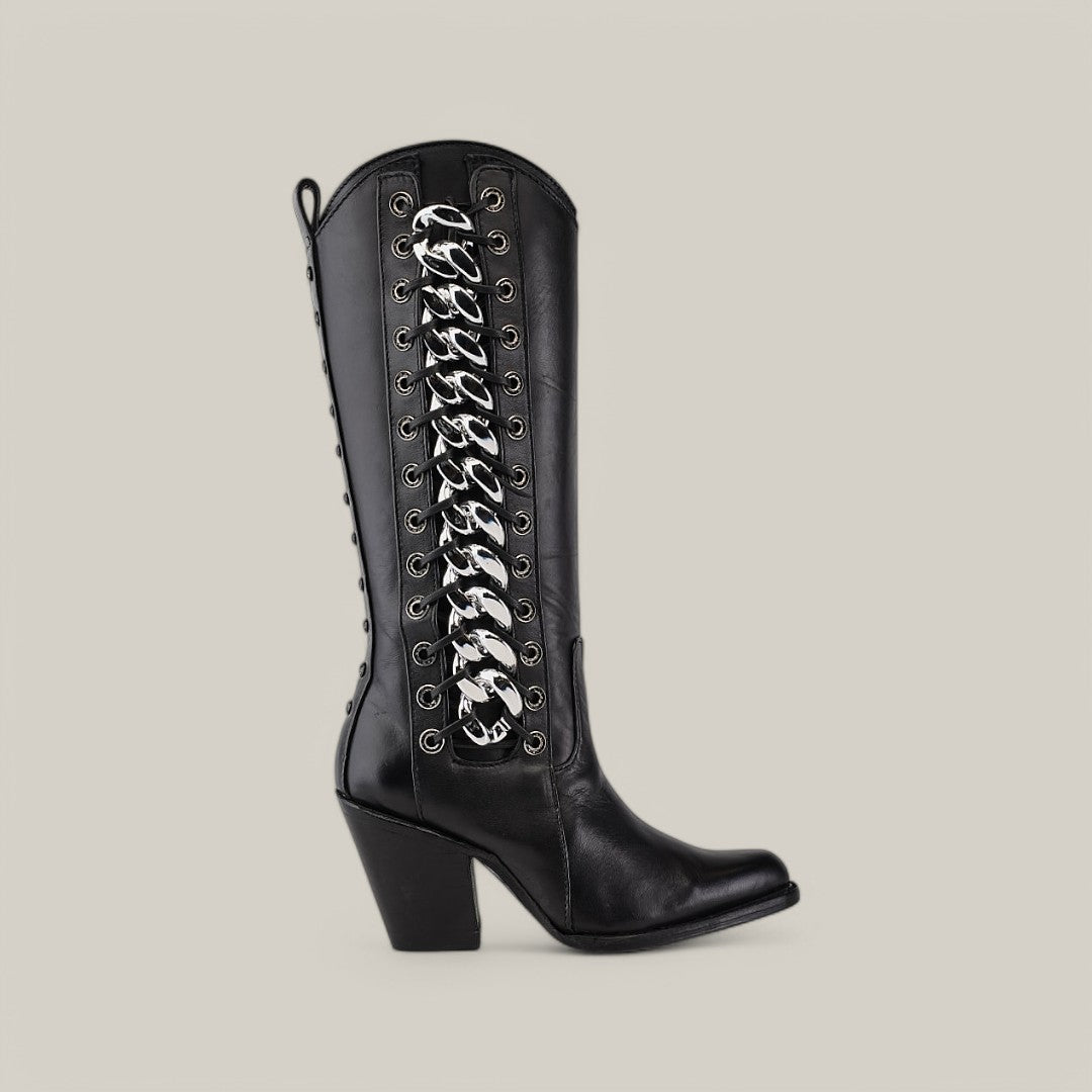 Meet the Francia Rings Tall Shaft Black - J Toe boot from our Platinum Collection: a sleek knee-high design with chunky heels, silver rings, and side laces. Made from shiny leather against a light backdrop, it offers an elegant yet bold statement.