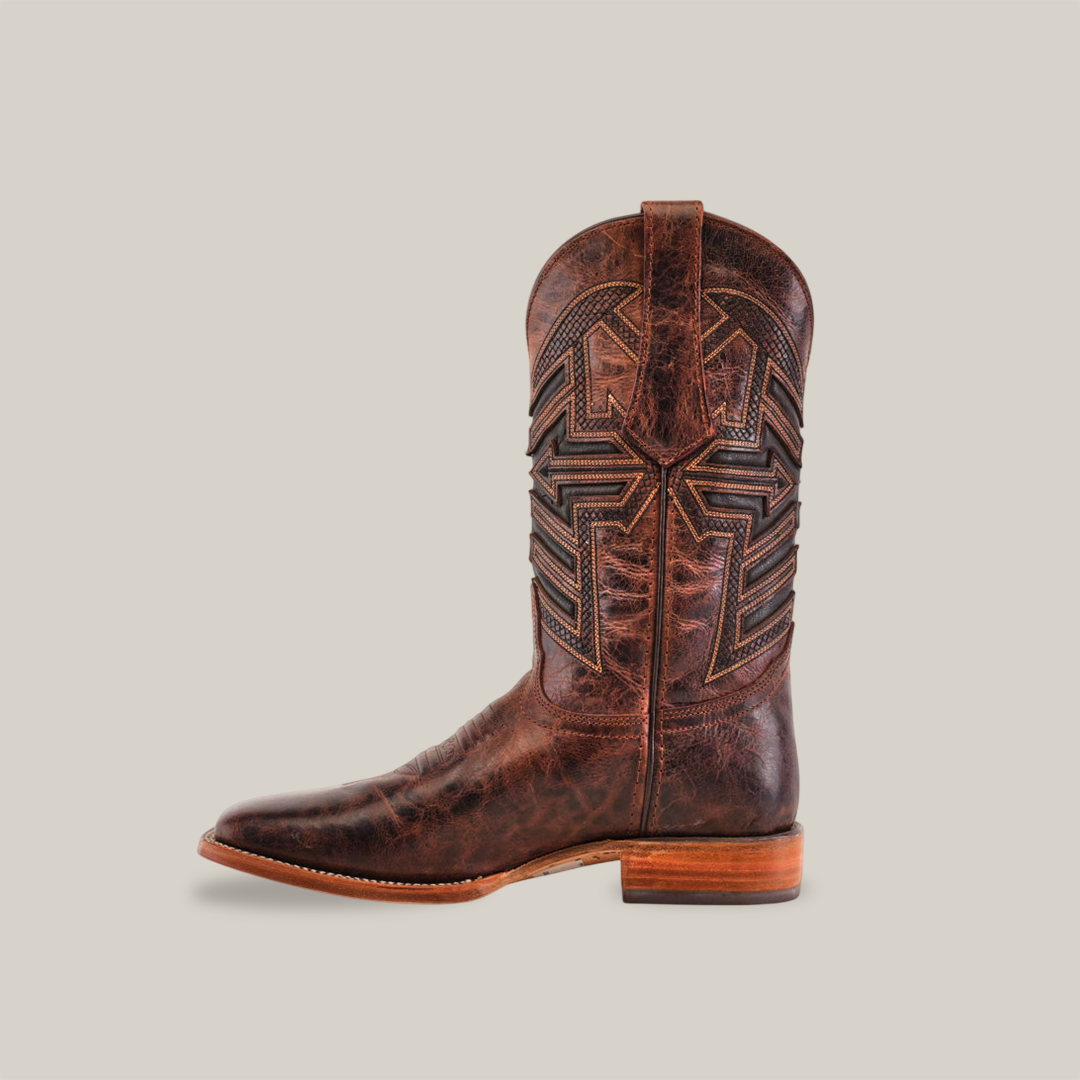 The Rustic Brown - Square Toe cowboy boot, crafted from rustic brown cowhide leather, features intricate shaft stitching. Its displayed on a plain white background, highlighting its elegant side profile and square toe design.