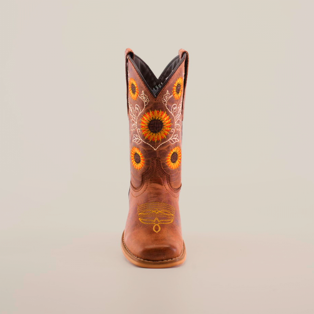 Part of the Sunflowers Tabaco - Square Toe collection, this single cowboy boot highlights superior craftsmanship with intricate yellow and orange sunflower embroidery on the shaft, set against premium brown leather, all viewed on a plain white background.