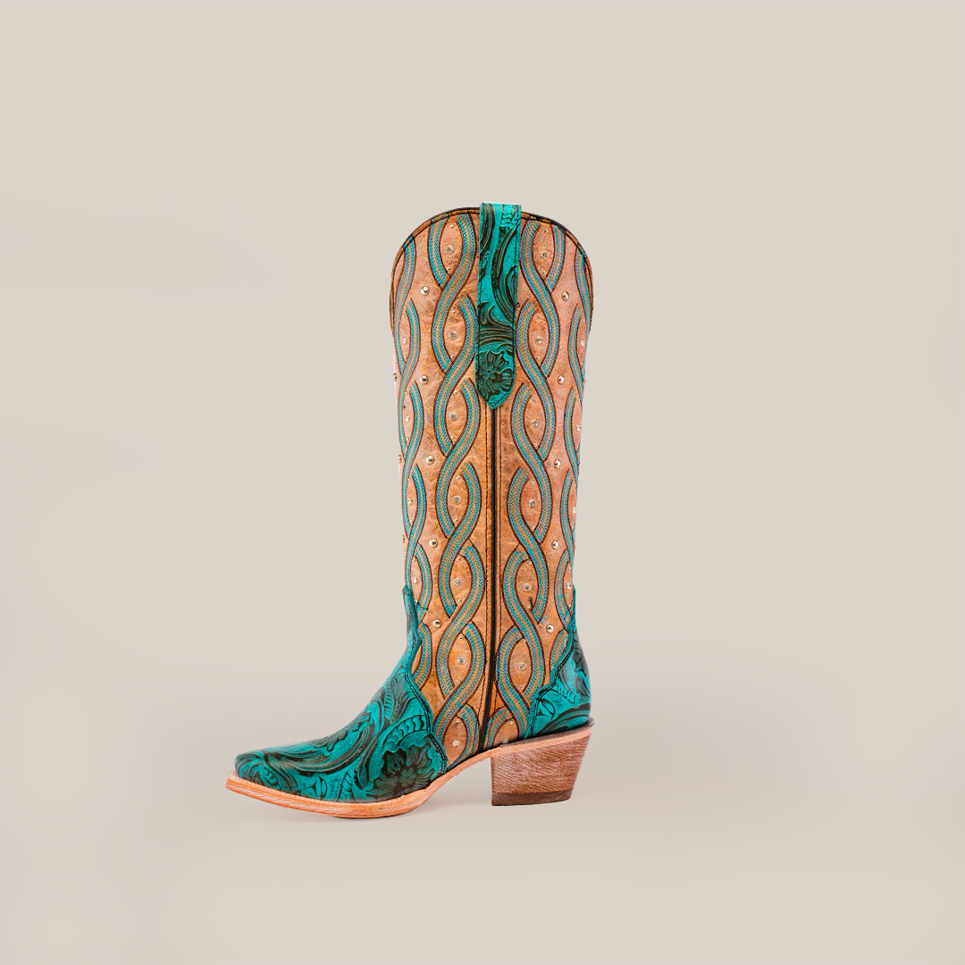 Against a plain white background, the Premier Turquoise Handtooled Flowers cowboy boot stands upright, featuring a tall shaft and snip toe. Crafted from premium leather, it showcases intricate teal and tan swirling patterns reminiscent of turquoise handtooled flowers.