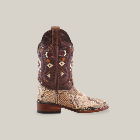 The Exotic Python Patchwork boot showcases a brown upper with embroidered geometric designs and premium light python leather lower. It features a natural square toe, flat wooden heel, and structured design, all set against a plain white background.