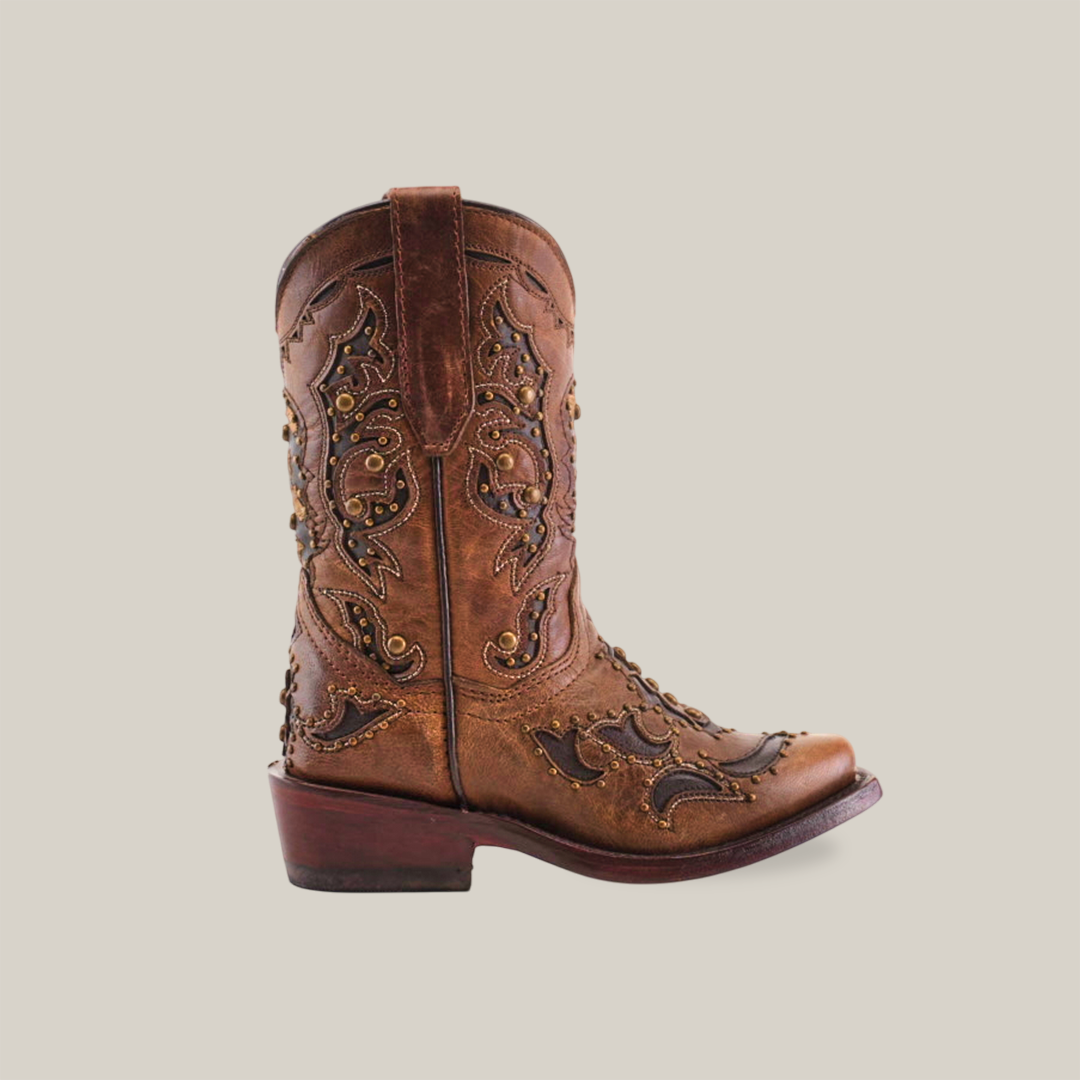 The Arass Studs Orix boots feature a vintage-looking brown cowhide leather with intricate embroidery and side studs, a snip toe design, decorative stitching, and a short heel. Theyre perfect for adding rustic charm, even in childrens sizes!.