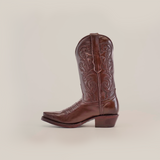 The Plane Jane Moka cowboy boot combines Western aesthetics with intricate embroidery, a snip toe, and a low heel. Crafted meticulously from premium leather, this boot is displayed against a plain white background.