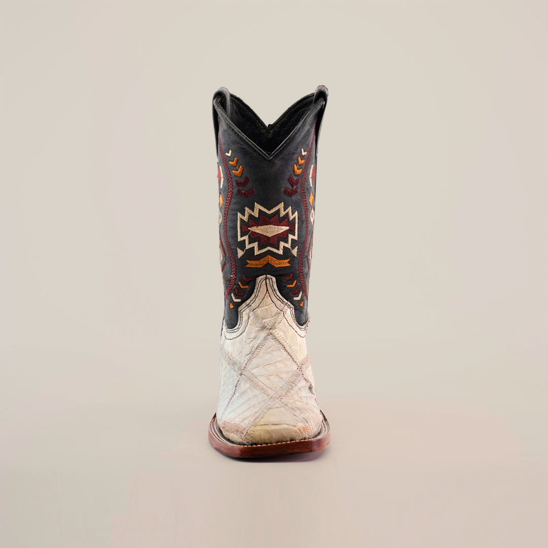 A single Exotic American Alligator Patchwork Bone Square Toe cowboy boot is shown facing forward on a white background, featuring a dark shaft with colorful geometric embroidery and a light-colored textured foot resembling alligator skin.