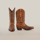 The Nirvana Tabaco - Short Shaft - Snip Toe boots showcase a Western charm with ornate designs and decorative studs. Set against a white background, one boot stands upright while the other is slightly angled.