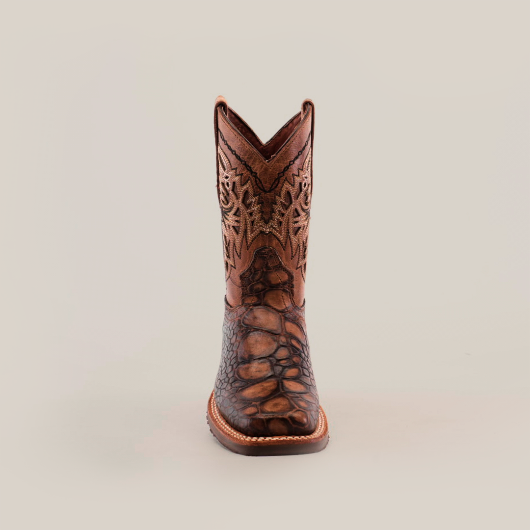 The Loggerhead Turtle Print brown Rodeo Toe cowboy boot boasts a detailed design with intricate shaft patterns and a rugged foot texture, all crafted from premium cowhide leather and showcased against a plain white background.