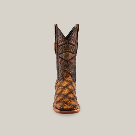 A single Big Bass Pirarucu Print Rustic Honey boot with a pointed toe showcases a detailed geometric pattern on rich two-tone brown leather, with the lower resembling reptile scales. The light-colored sole contrasts beautifully.