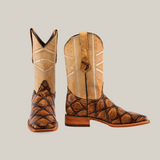 A pair of Big Bass Pirarucu Print Rough Orix - Square Toe boots is showcased against a white backdrop. The boots feature light tan shafts with white stitching, dark brown textured leather on the foot, and are completed with a classic wooden sole.