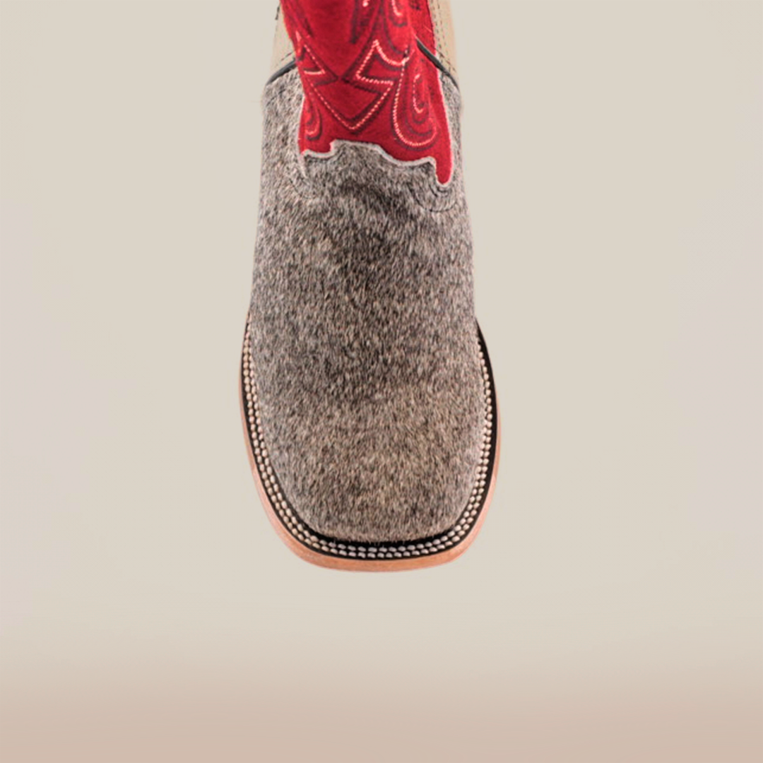 Introducing the Cowhide Hair Pinto Square Toe boot—a close-up reveals a gray textured leather foot with red embroidery on the upper. This design showcases a square toe with detailed sole stitching, perfectly blending rugged charm and refined craftsmanship.