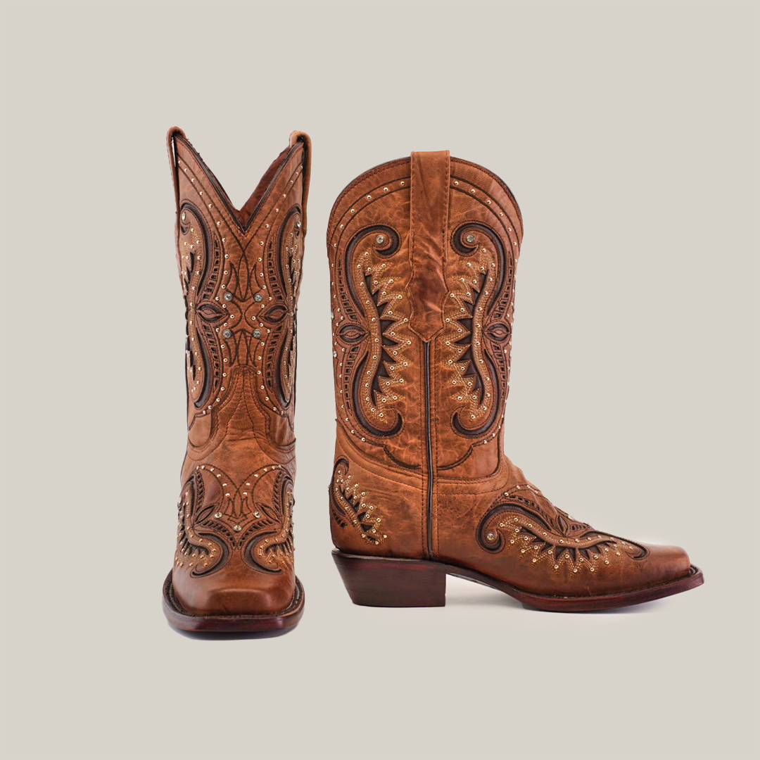 A pair of Croella Orix Crystals short shaft cowboy boots, in handcrafted brown leather with intricate stitching, are on a white background. One boot is upright, and the other is slightly tilted, highlighting detailed patterns and a classic Western design with premium craftsmanship.