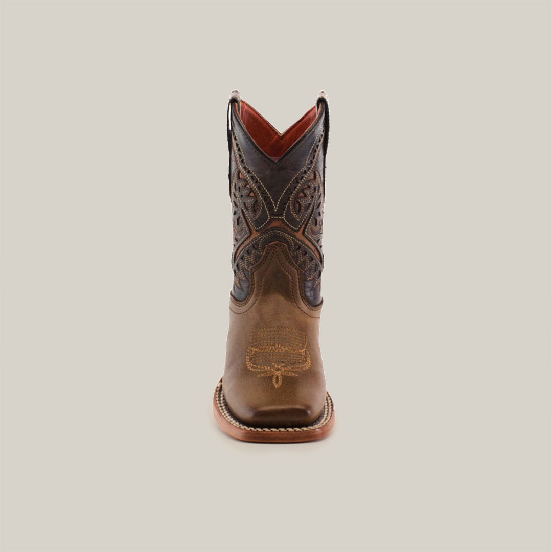 The Ranch Camel Square Toe is a single brown cowboy boot made from cowhide leather, featuring intricate stitching and a slightly pointed toe, displayed upright against a white background. It captures western elegance with a darker upper section adorned with detailed patterns.