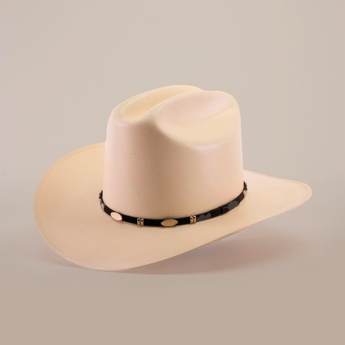 The 1000X Dos Carnales Straw Hat is a beige cowboy hat with a wide, curved brim and a black band featuring light decorative elements. Its exceptional quality and craftsmanship are highlighted against a plain background, making it an iconic accessory.
