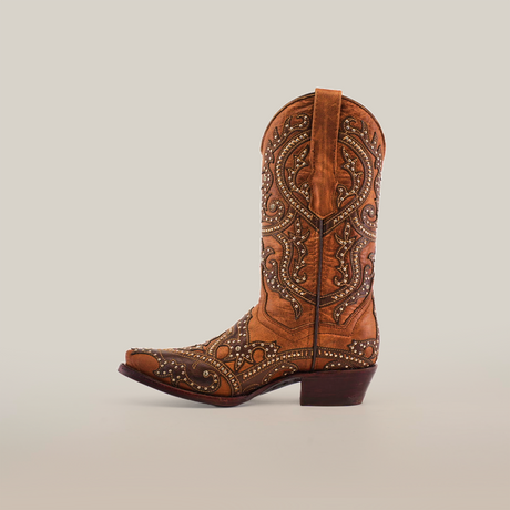 A Nirvana Tabaco cowboy boot with a short shaft and snip toe, featuring intricate embroidery and studs, stands out against a white background, capturing the Western style.