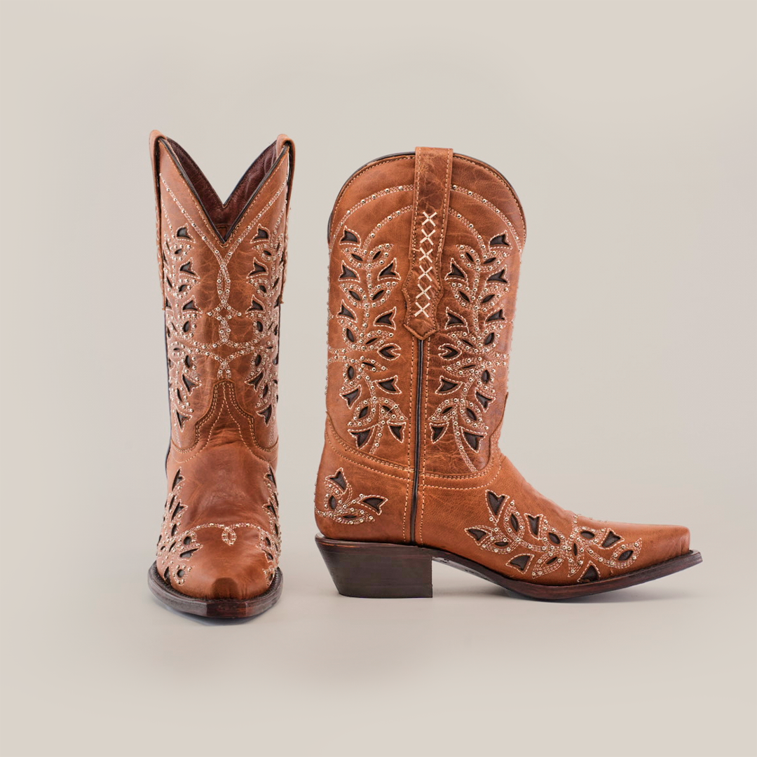 The Flipy Honey - Short Shaft - Snop Toe boots offer intricate floral cut-out designs and decorative stitching on the shaft. Crafted with traditional bootmaking artistry, they feature a premium leather sole against a crisp white background.