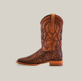 The Handtooled Leave Brown - Square Toe boot, crafted from premium cowhide leather, features intricate floral patterns, detailed stitching, a wooden heel, and classic western design against a plain white background.