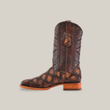 The Big Bass Pirarucu Print Rustic Brown - Square Toe boot is showcased against a white background, featuring intricate pirarucu print patterns, a textured design, and a wooden sole with a low heel.