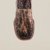 Close-up of the Cowhide Hair Fawn Square Toe boot, featuring a cowhide hair texture in brown and black. The square toe has intricate stitching on the leather upper, complemented by a fawn finish and light brown sole.