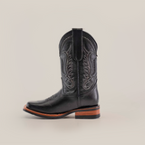 The Barcelona Black Slip Resistant Sole Rodeo Toe is a premium leather cowboy boot with intricate stitching, featuring a pointed rodeo toe and wooden heel. It sits elegantly against a plain white background.