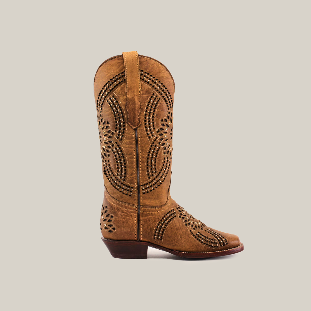 A single brown cowboy boot, named Flor Crystals Studs, handcrafted from premium leather and showcasing decorative perforations, is displayed on a white background. It features a low heel and a narrow square toe.