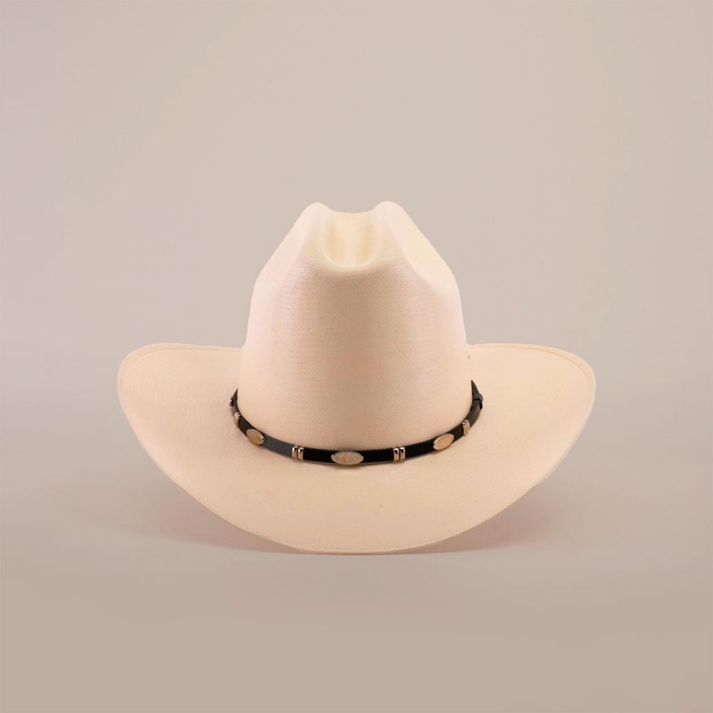 The 1000X Dos Carnales Straw Hat, an exceptional beige cowboy hat with a black band and decorative white oval accents, is displayed against a plain white background.