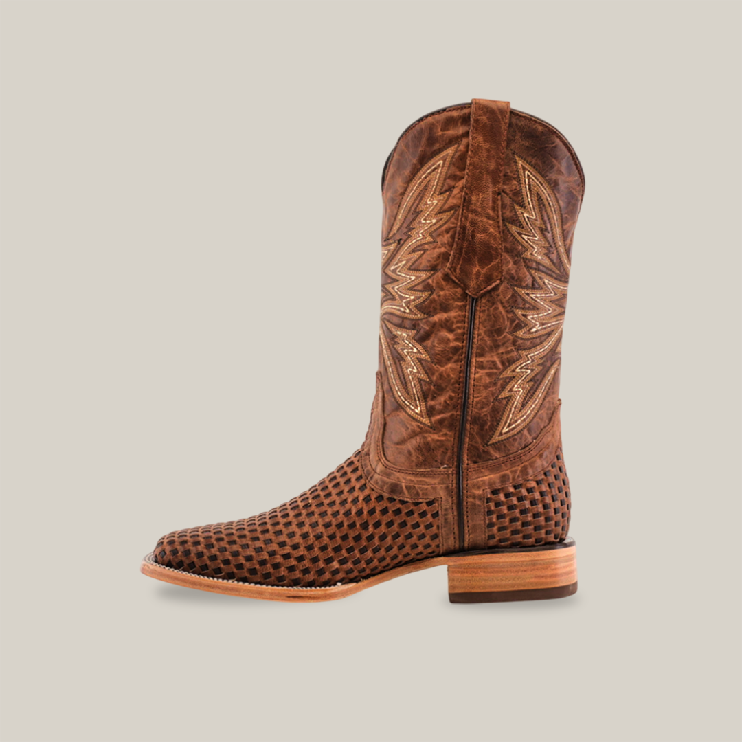 The Texas Basket Weave Orix - Square Toe cowboy boot is made from premium cowhide leather and sports an intricate pattern on the foot, decorative stitching on the tall shaft, a classic wooden heel, pull strap, and square toe for modern flair against a plain white background.