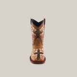 The Margacruz Studs Orix - Square Toe, a single brown cowboy boot, handcrafted from premium leather, features ornamental stitching with floral and cross designs in white and black. It stands upright against a plain white background.