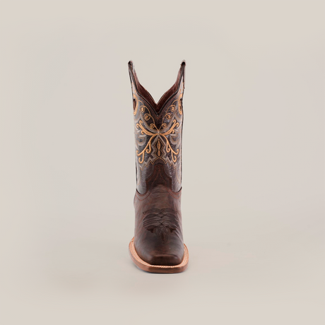 The Western Stitch Tabaco boot, featuring a narrow square toe and short shaft, is made from superior leather with intricate yellow stitching on a white background.