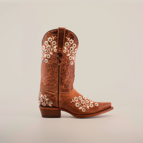 The Abril Crystals boot features a brown design with intricate white floral embroidery on the shaft and foot. This western-style boot has a snip toe, short heel, subtle crystal embellishments, all set against a plain white background.