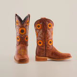 The Sunflowers Tabaco - Square Toe boots are crafted from premium leather and boast sunflower embroidery with decorative stitching. Displayed on a pristine white background, one boot faces forward while the other is shown in profile.