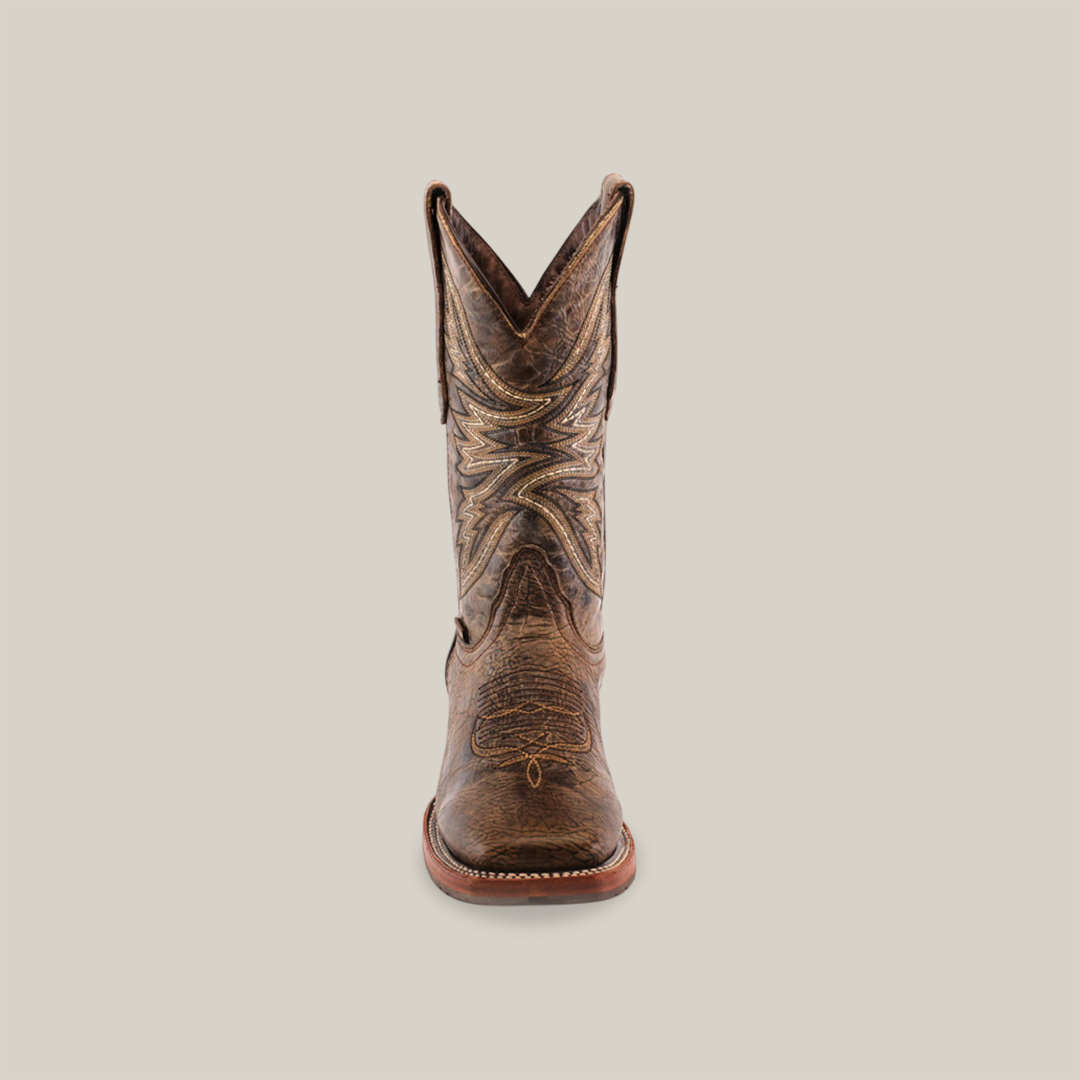 The Rustic Camel Brown boot displayed on a white background features a square toe and slip-resistant wooden sole, crafted from premium cowhide leather. It stands upright with intricate stitching visible.