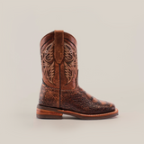 A Loggerhead Turtle Print brown Rodeo Toe cowboy boot, made of premium cowhide leather with detailed stitching, stands upright on a plain white background. It features a decorative pattern on the shaft and a low wooden heel.