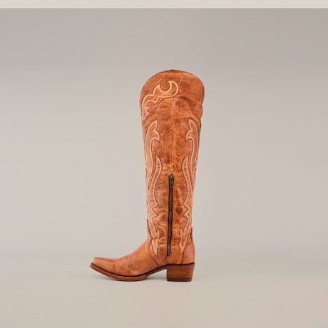 Tania Fawns Tall Shaft - Snip Toe boots are a tan knee-high leather cowboy style with intricate embroidery and a side zipper, featuring a luxurious leather sole against a plain light gray background.