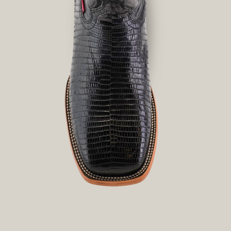 Close-up of the Exotic Lizard - Black cowboy boot featuring a lizard-textured design, square toe, brown sole, and intricate edge stitching. The boot is set against a plain white background.