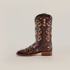 The Maya Brown Short Shaft boots feature premium leather and intricate tan and beige geometric embroidery on the shaft and foot, with a square-toe design and wooden heel. They are elegantly displayed against a plain light background.