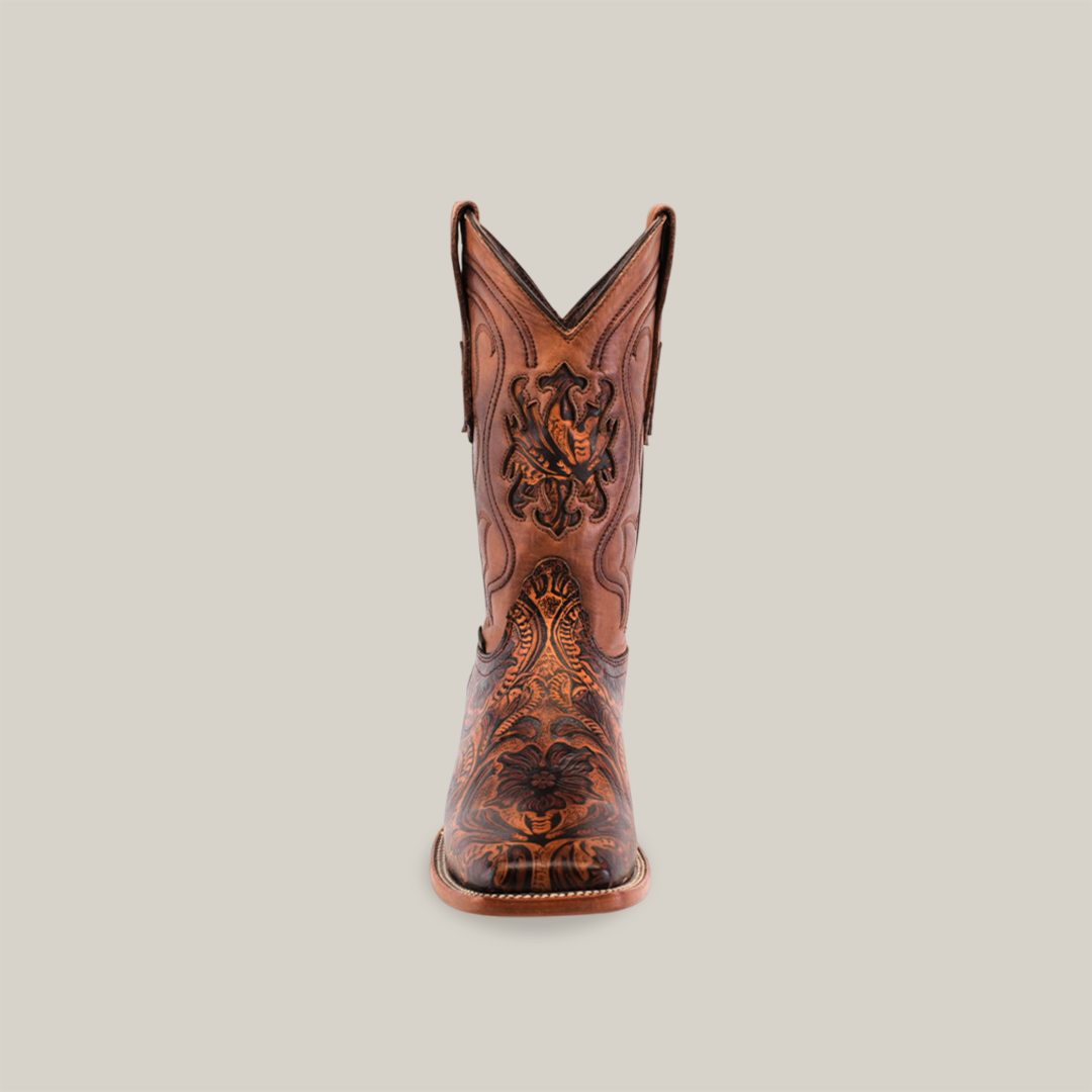 The Handtooled Leave Orix - Square Toe, a premium cowhide brown cowboy boot, showcases intricate dark embroidery and a pointed toe while standing upright on a plain white background.