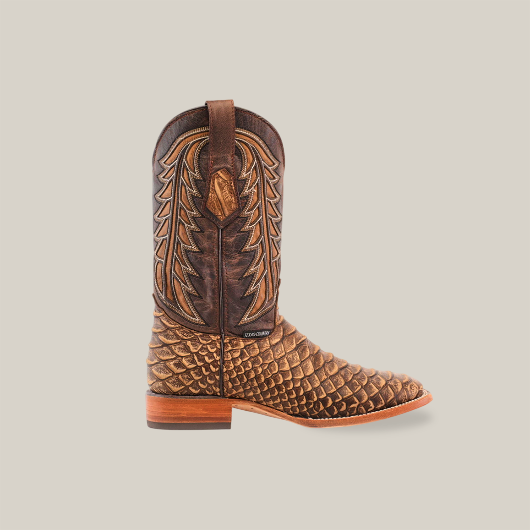 The Jumbo Python Print Cappuccino - Square Toe cowboy boot features a leaf-stitched decorative upper and a scale-textured lower. Crafted from premium cowhide leather, it includes a pull strap on top and a low wooden heel, displayed against a plain white background.