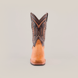 The Cater Honey features a single cowboy boot crafted from premium cowhide leather, boasting a brown lower section and a dark upper with intricate stitching. Its Western patterns offer a textured, colorful contrast atop the slip-resistant sole.